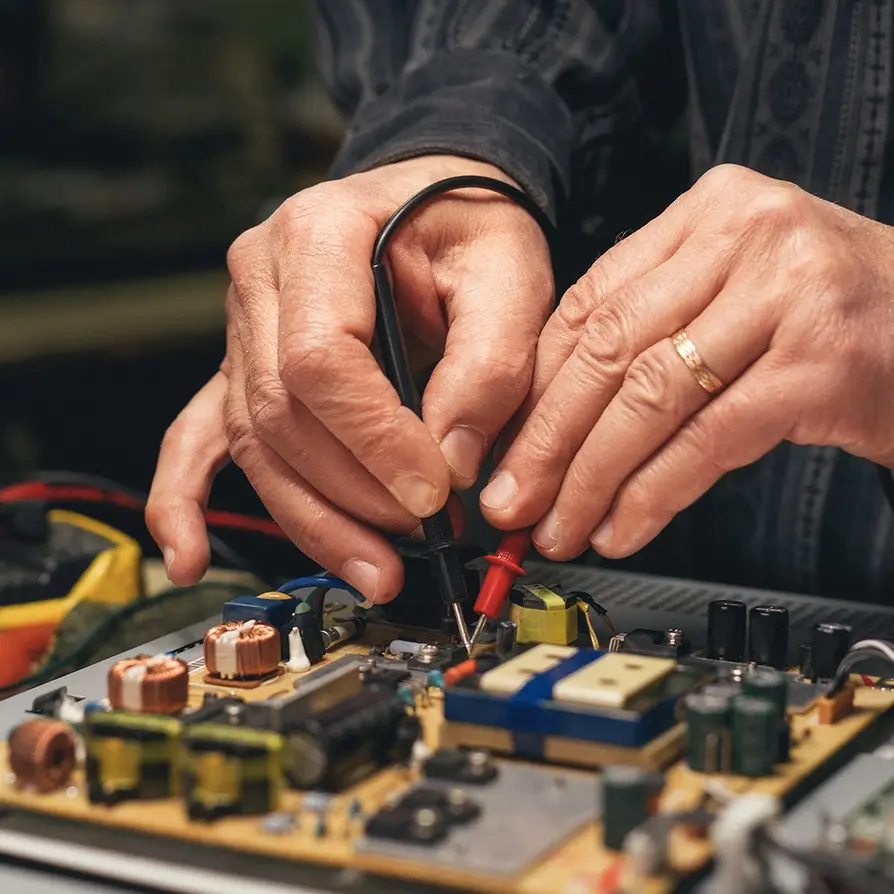People repairing electronics at home